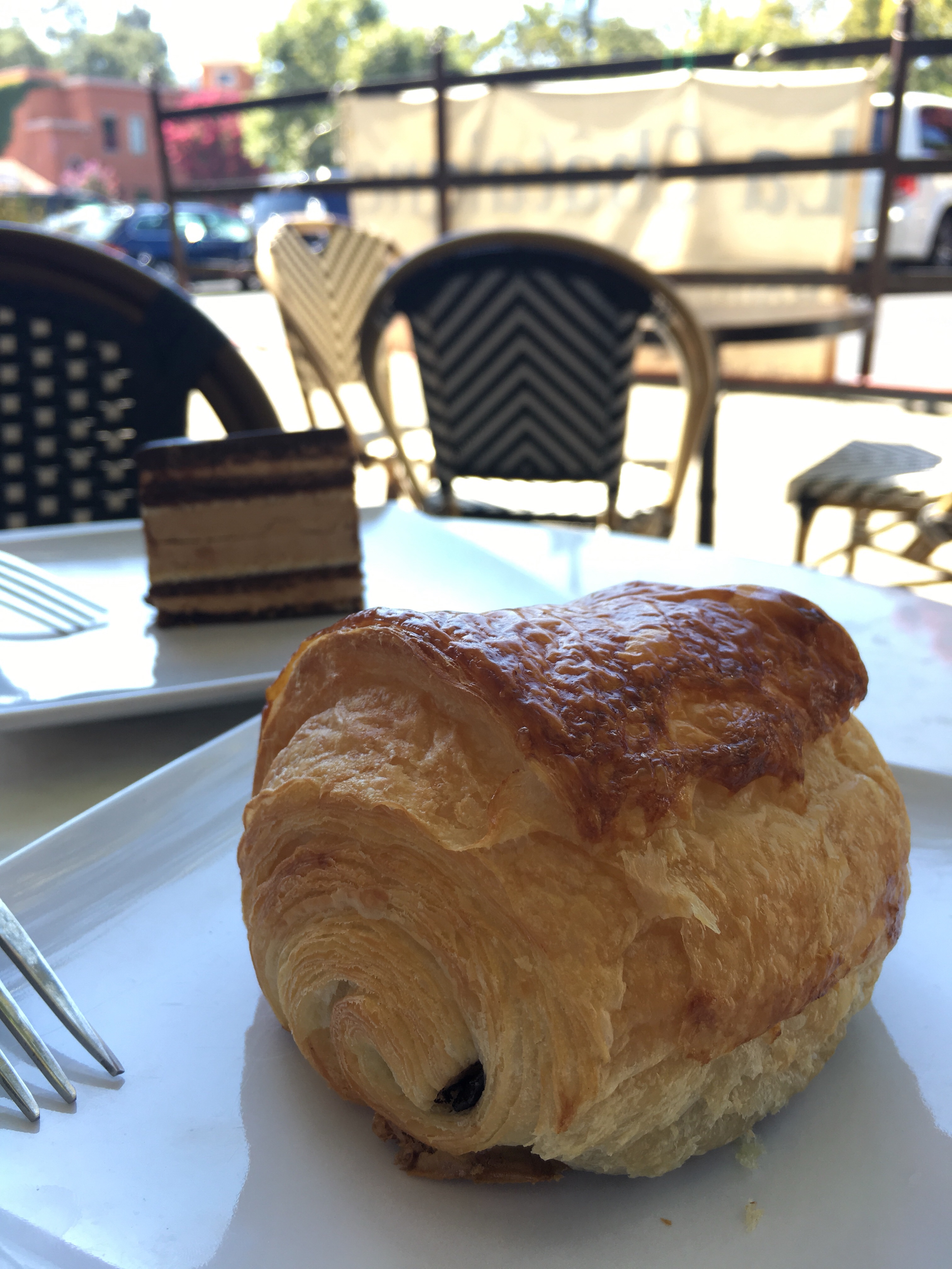 chocolate croissant and fork on a small plate
