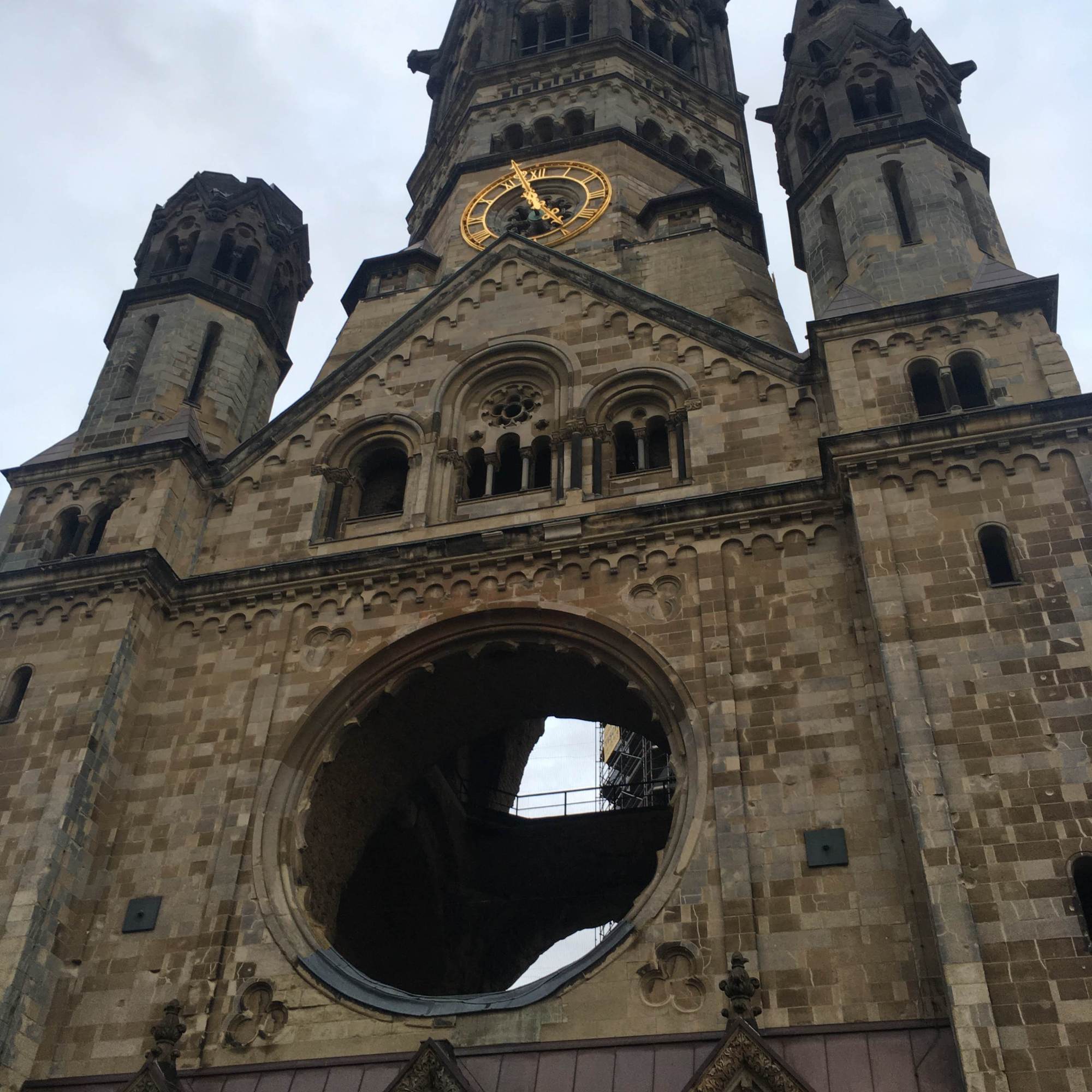 front of neo-romanesque church with gold clock