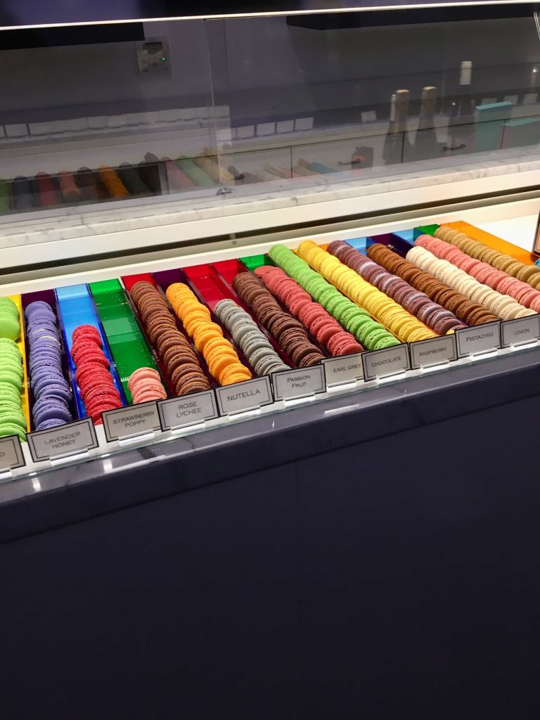 Colorful macarons in a glass display case